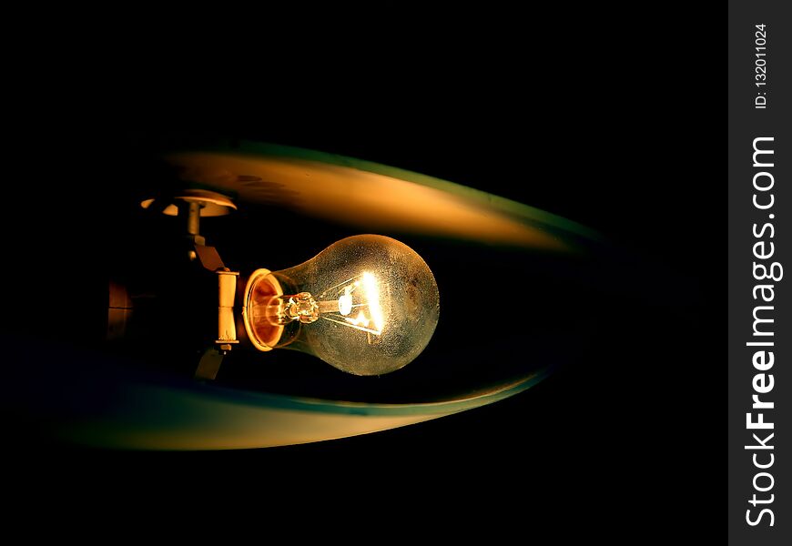 Ceiling lamp glowing in the black background