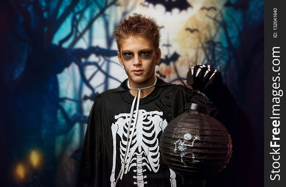Portrait of young boy in skeleton costume with makeup. Celebration of holiday Halloween, the boy in the image, the skeleton theme