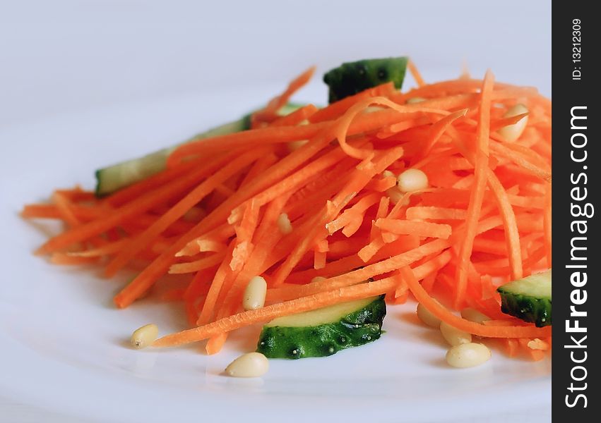 Salad with fresh carrot, cucumners and cedar nuts. Salad with fresh carrot, cucumners and cedar nuts.