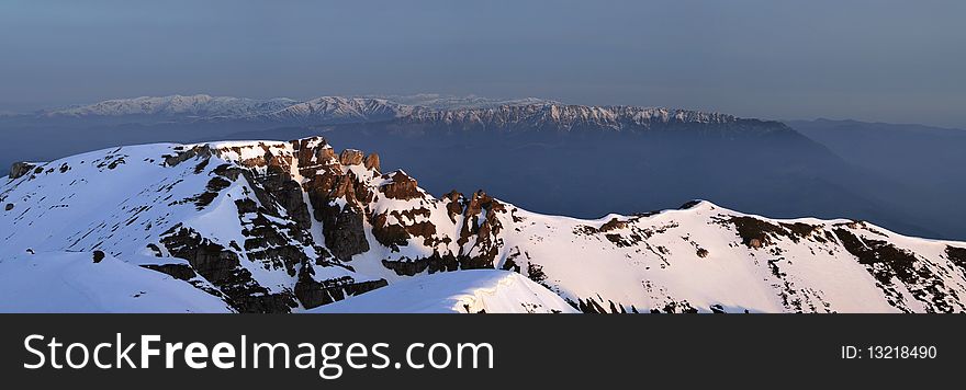 Panoramic Picture with sunrise in Carpathians Mountain, Romania, Bucegi Summit, from Vf.Omu Peak, and Piatra Craiului Mountain far away. Panoramic Picture with sunrise in Carpathians Mountain, Romania, Bucegi Summit, from Vf.Omu Peak, and Piatra Craiului Mountain far away.