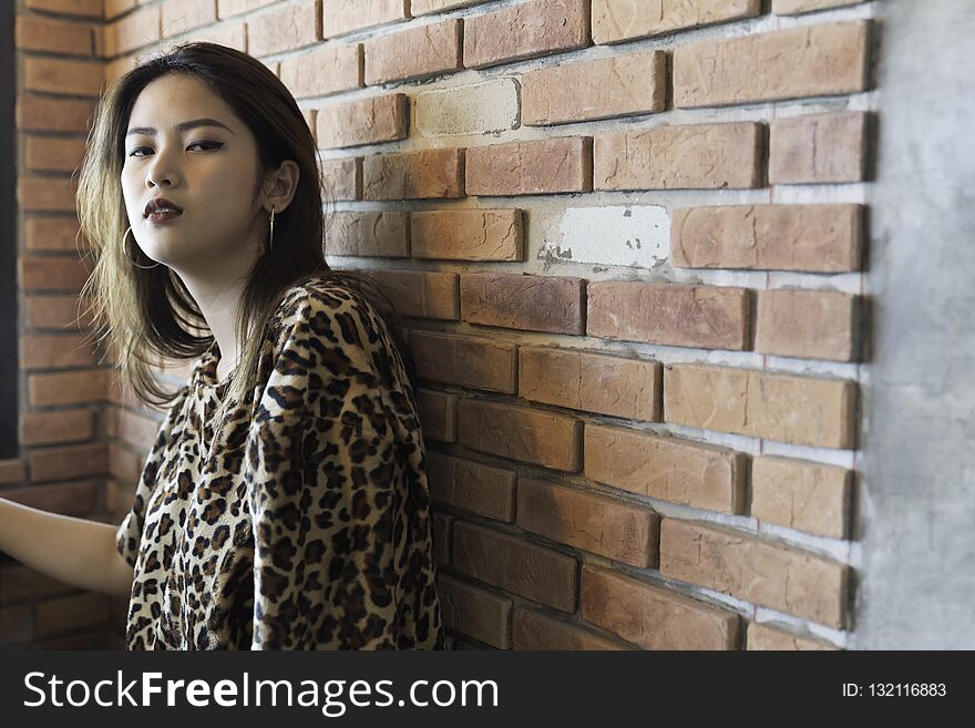 A beautiful woman portrait. Asian teenager concept, with tiger line shirt in the vintage cafe