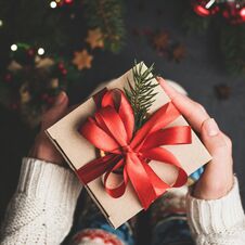 Christmas Gift Box With Red Lace In Hands Stock Image