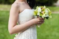 Beautiful Wedding Bouquet In Hands Of The Bride In Park Stock Photo