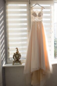 Wedding Preparations - Beautiful Wedding Dress On A Custom Hanger Royalty Free Stock Images