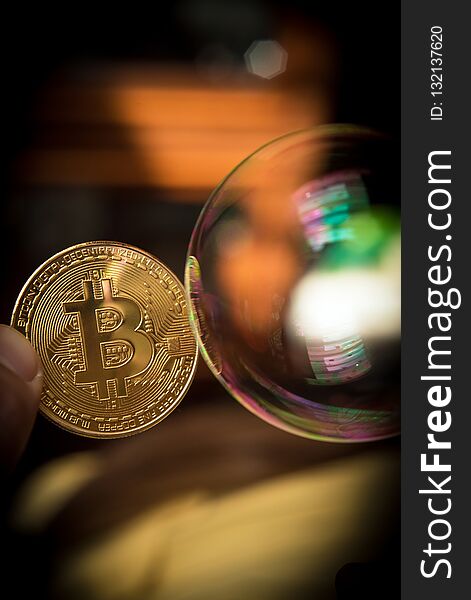 Bitcoin and the bubble as an abstract symbol of the risks of a digital currency and possible collapse and abrupt change of course falling, collapse, fiasco, fraud - the concept