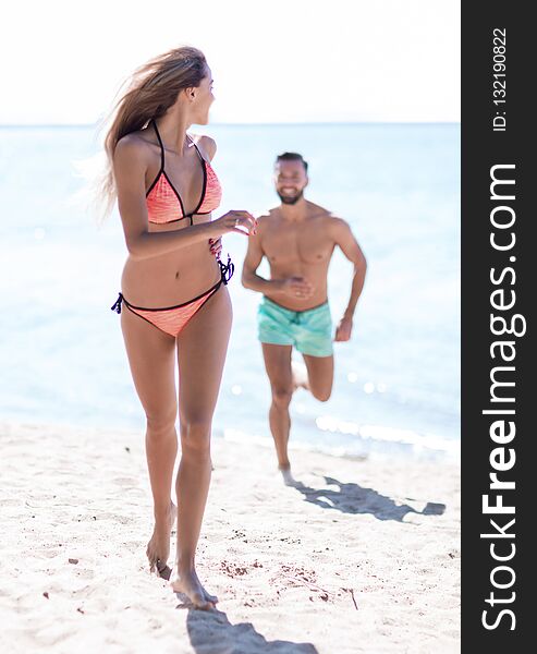 Happy fun beach vacations couple walking together laughing havin