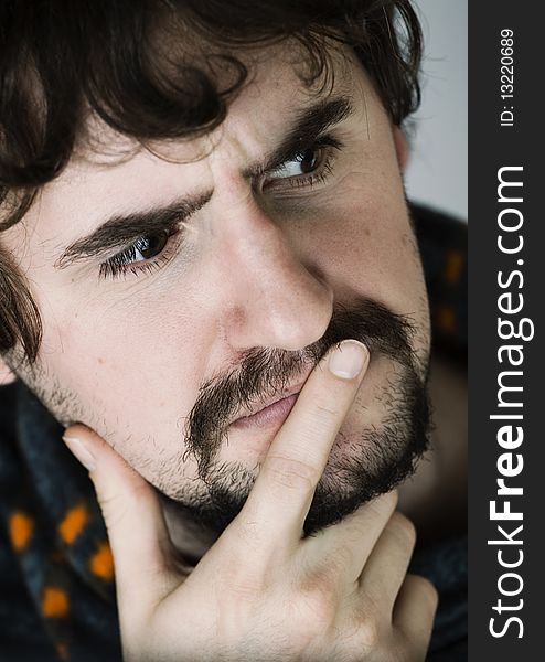 Close up portrait of thoughtful young man