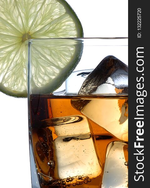 Drink with slice of lime, closeup on ice cubes