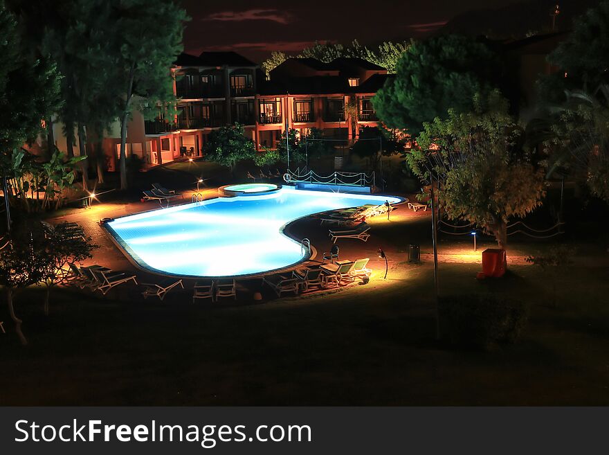 View From Window In Evening On The Courtyard Of Hotel With A Swimming Pool