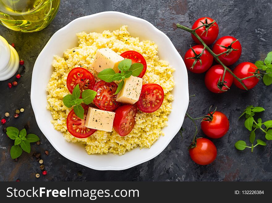 Millet porridge with tomatoes and cheese. Top view