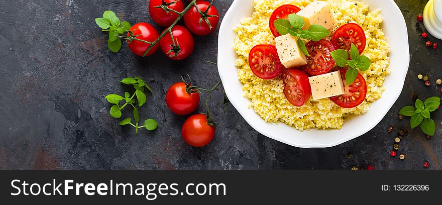 Millet porridge with tomatoes and cheese. Top view. Banner