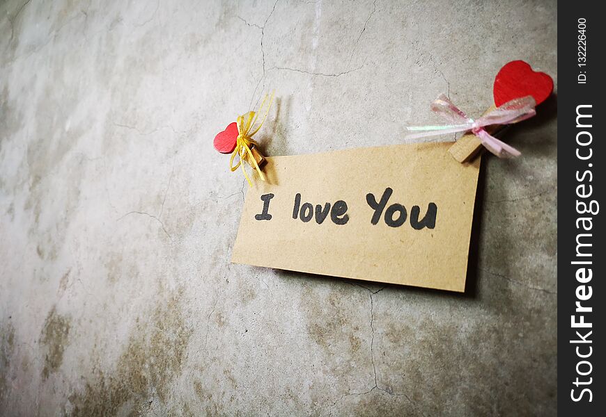 A note I Love You written on a piece of paper on the wall. A note I Love You written on a piece of paper on the wall