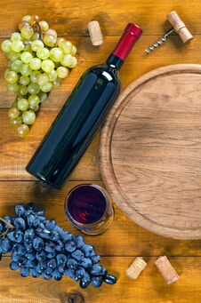 Bottle And Glass With Wine, Grapes, Corkscrew, Cork On Wooden Ba Royalty Free Stock Photos