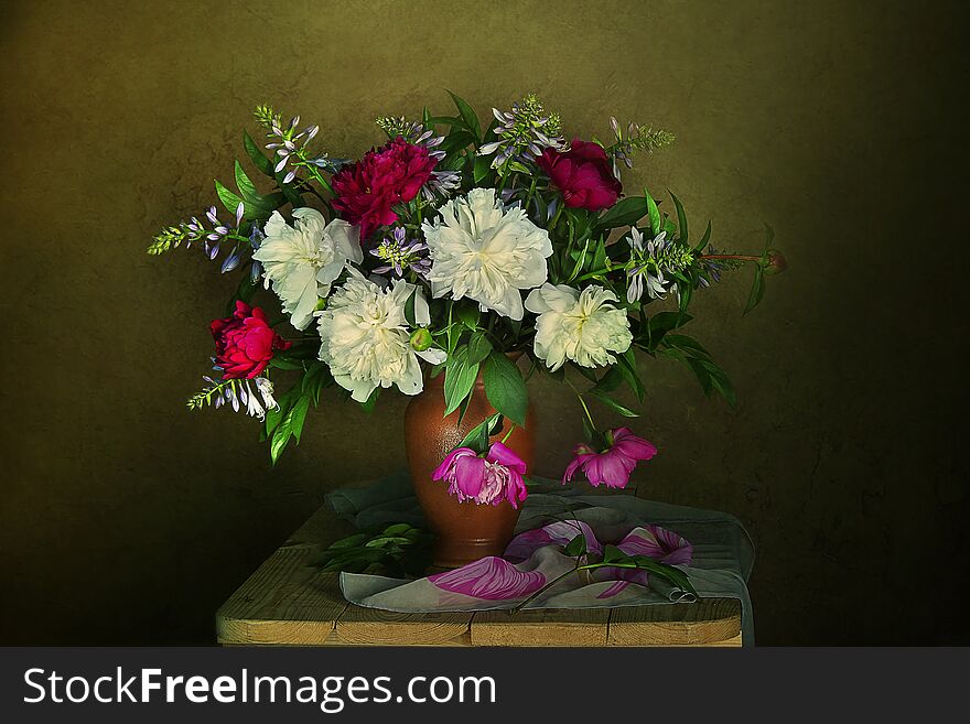 Bouquet of pink and white peonies in a vase on the table