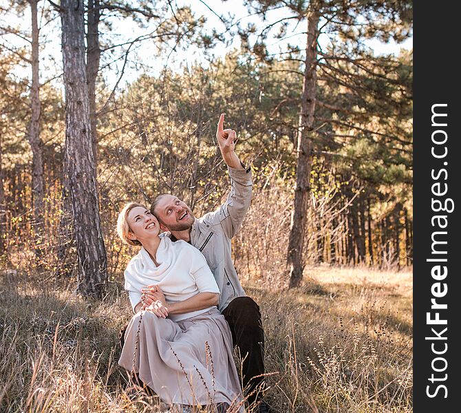 Beautiful young couple in love hugging in the autumn forest. Beautiful young couple in love hugging in the autumn forest.