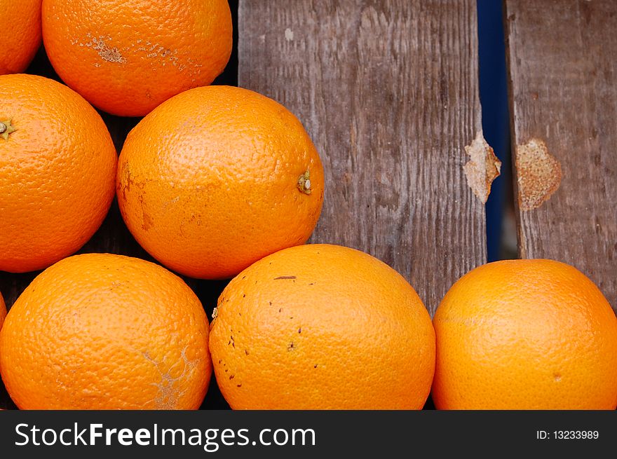 Some oranges in a wooden box