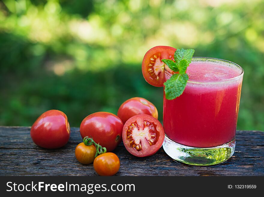 Tomato Juice On Wooden With Tomato Be Side And Mint Leaves On To