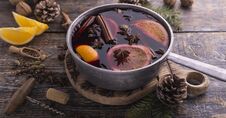 Christmas Traditional Drink, Mulled Wine With Cinnamon Sticks, Anise Stars, Orange Fruits On A Wooden Background. Copy Royalty Free Stock Photos