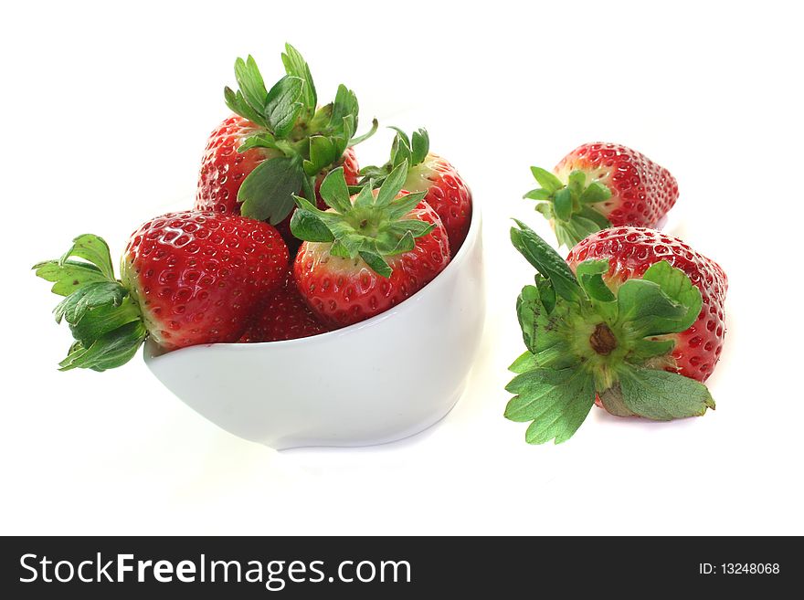 Strawberries in a bowl on a white background