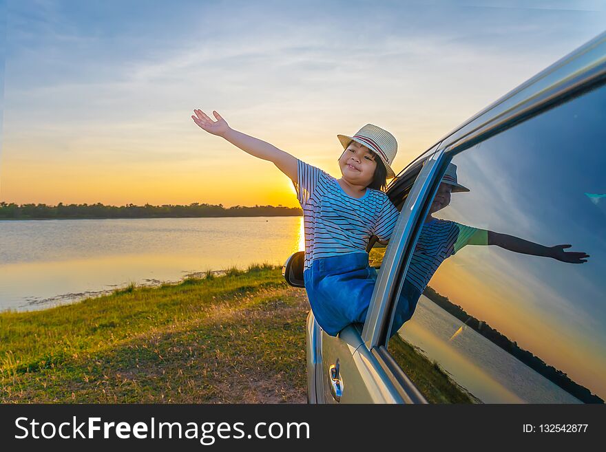 Childern are playing on the lake at sunset. People have fun on the field. People have fun on the field. Family Friendly Concept and Summer Vacation.