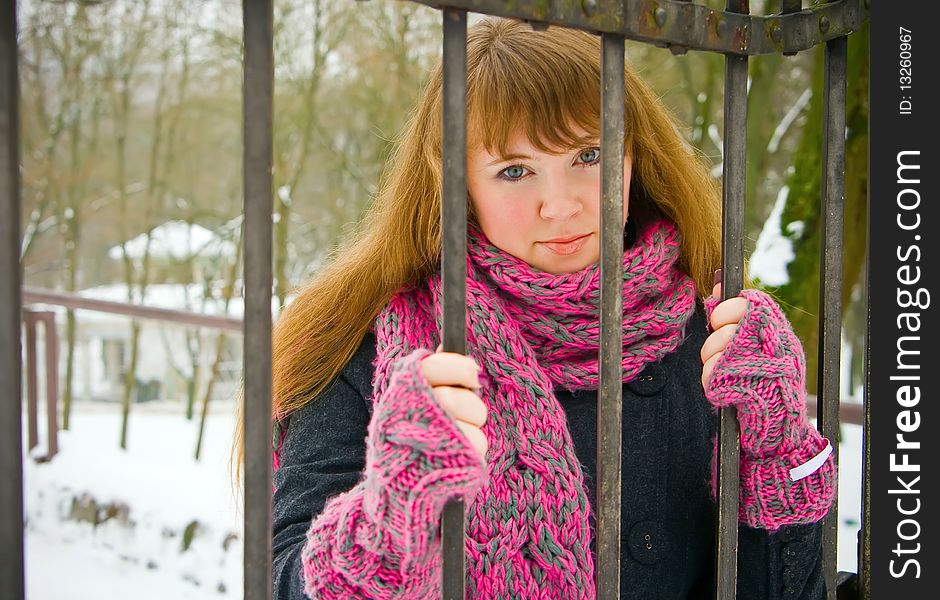 Woman Holding a Fence