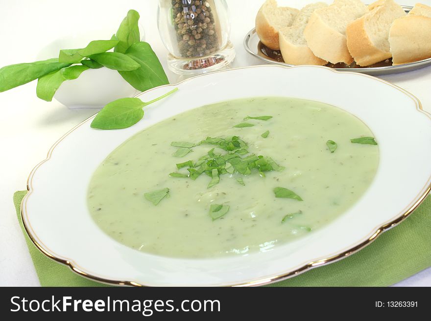 Herbs soup with fresh sorrel and baguette