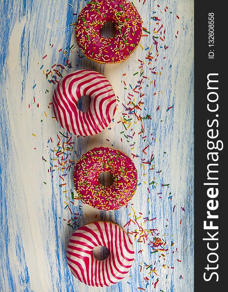 Donuts on a blue wooden background. Delicious dessert