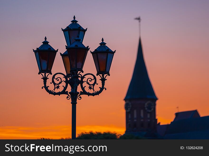 Koenigsberg cathedrlal silhouette at sunset, a street lamp in the foreground