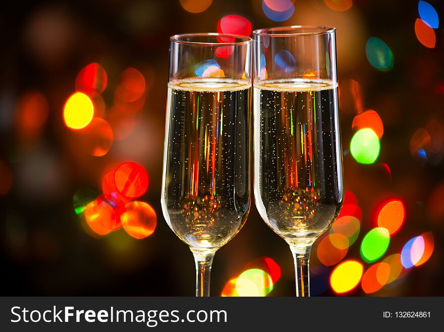 Champagne glasses on the background of Christmas lights. Champagne glasses on the background of Christmas lights