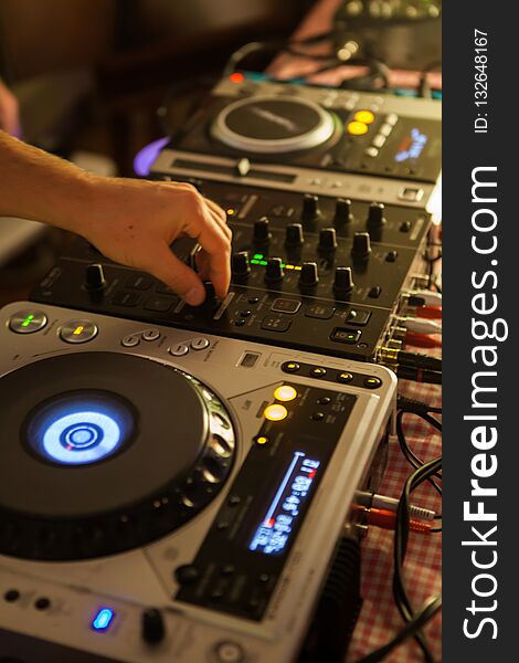 Dj mixing music on professional mixer in club. Dj mixing music on professional mixer in club