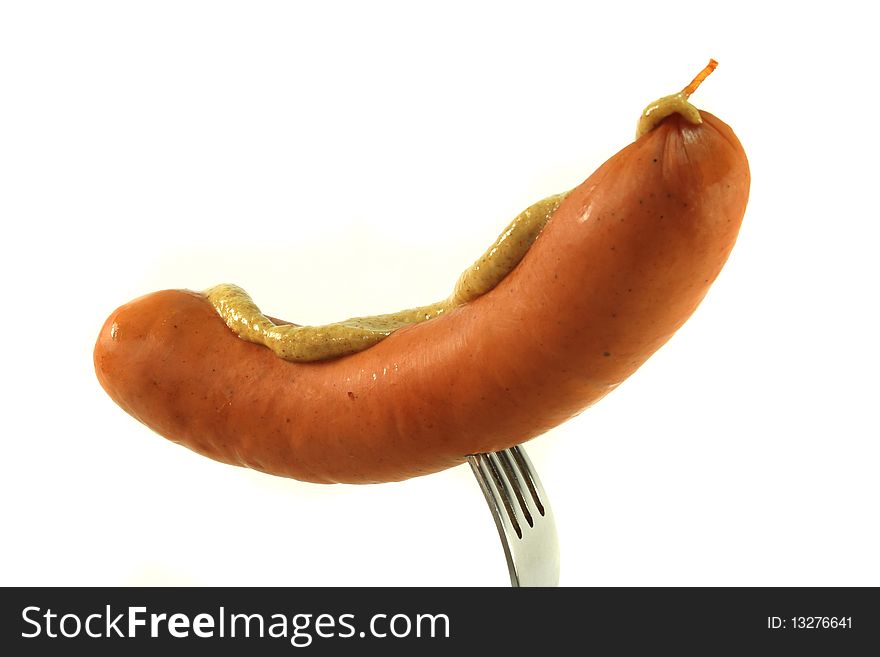 Sausage skewered on a fork