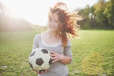 Young Redhead Girl In Casual Player In Soccer Stadium At Sunset Royalty Free Stock Photos