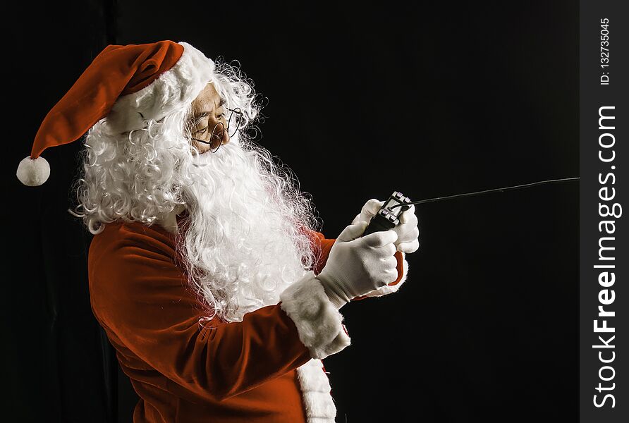 Santa Claus Playing Game Studio Shot On Black Background For Family, Giving, Season, Christmas, Holiday, New Year, Travel, Christi