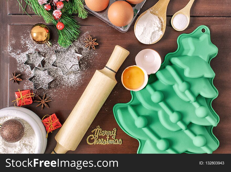 Christmas baking cake background. Ingredients and tools for baking - flour, eggs, silicone molds in the shape of a Christmas tree