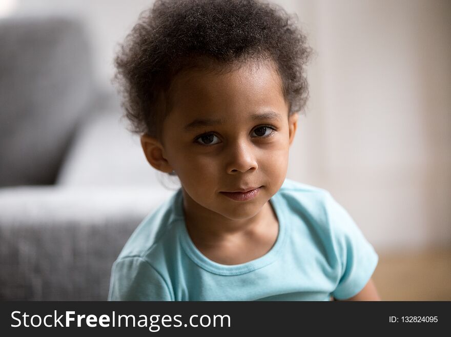 Head shot portrait cute beautiful toddler African American child, little pretty preschooler boy with curly hair, lovely kid, looking at camera. Head shot portrait cute beautiful toddler African American child, little pretty preschooler boy with curly hair, lovely kid, looking at camera