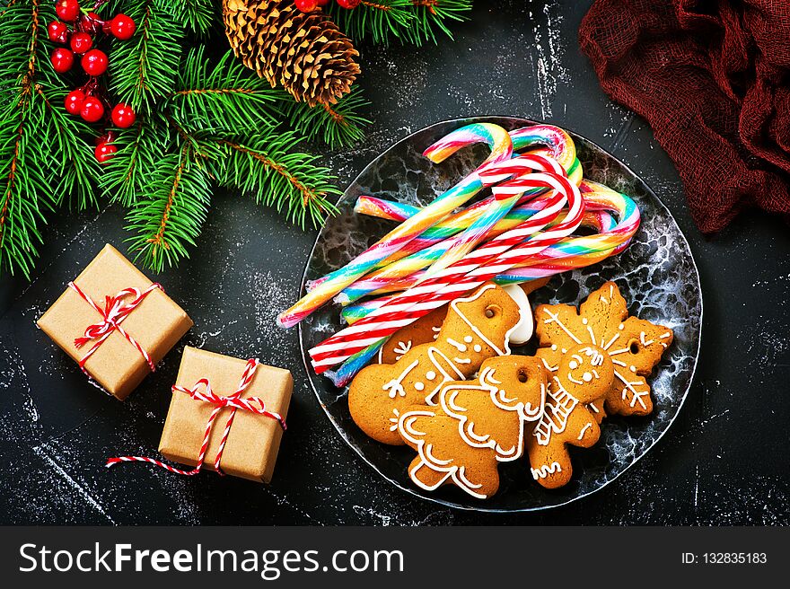 Cookies and candycane on a table, christmas background