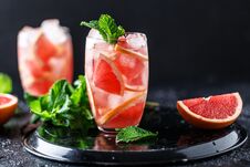 Fresh Grapefruit Cocktail. Fresh Summer Cocktail With Grapefruit And Ice Cubes. Glass Of Grapefruit Mojito Royalty Free Stock Photography