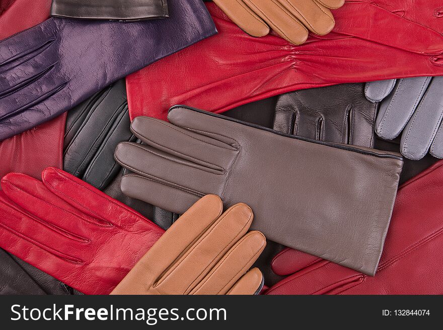 Scattered colored gloves. Leather gloves close up