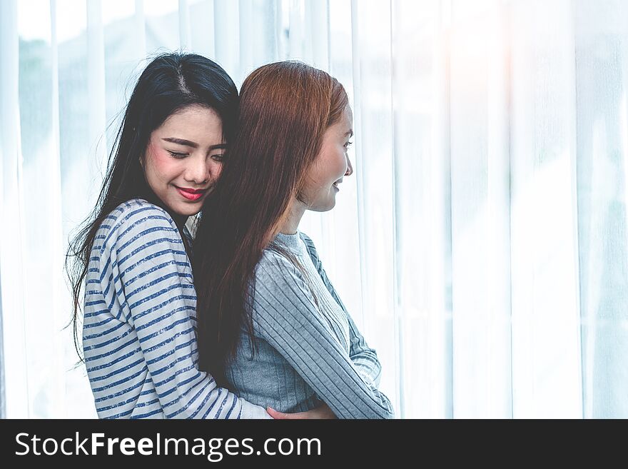 Two Asian Lesbian women hug and embracing together in bedroom. Couple people and Beauty concept. Happy lifestyles and home sweet home theme. Homosexual life theme. Love scene making of female