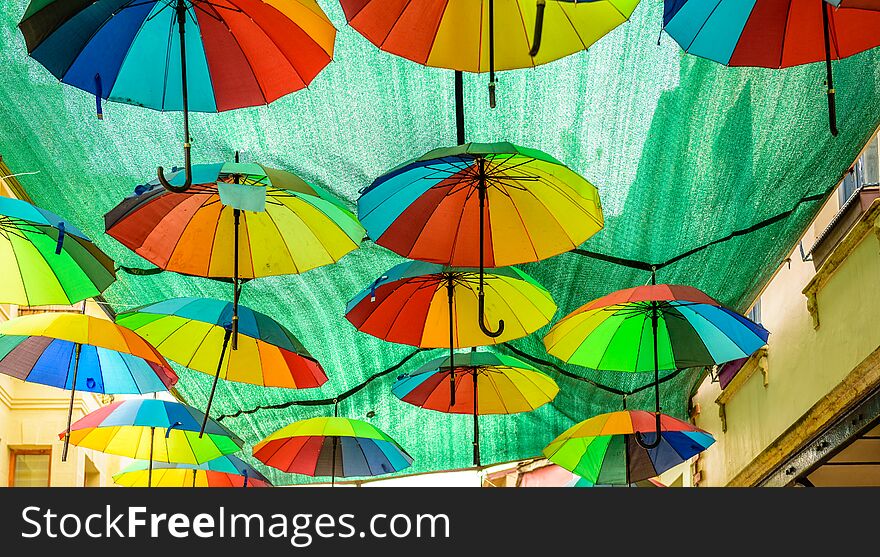 Colorful hanging umbrellas above the street on green sheet background in Istanbul,Turkey