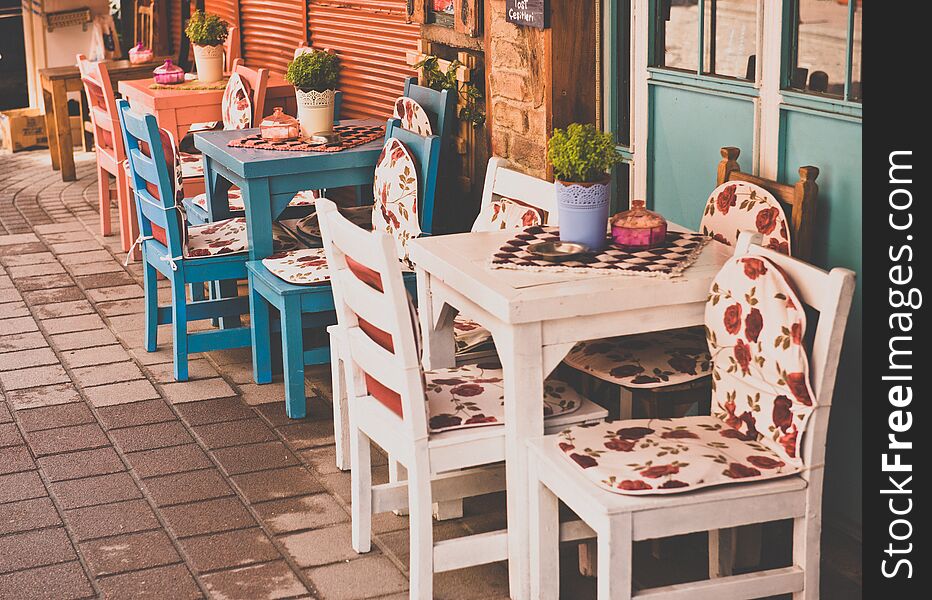 Retro, vintage view of Pastel coffee shop with wooden tables and chairs in Balat, old town of Istanbul, Turkey. Outdoor cafe. Photo in vintage image style.ISTANBUL, TURKEY