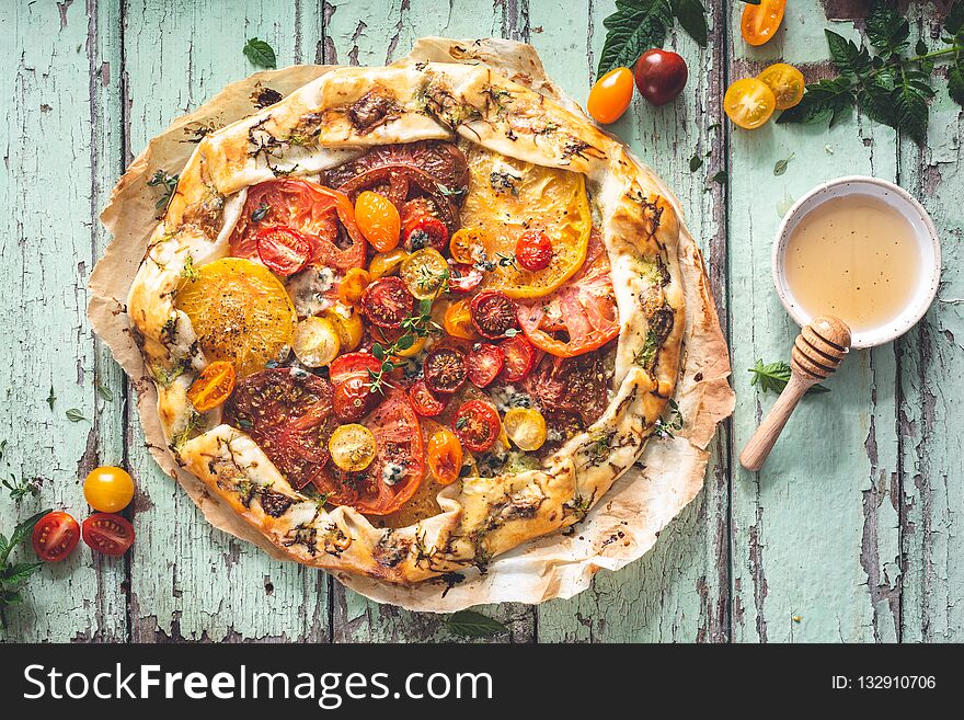 Tomatoes Tart with Fresh Tomatoes and Cheese on wooden background