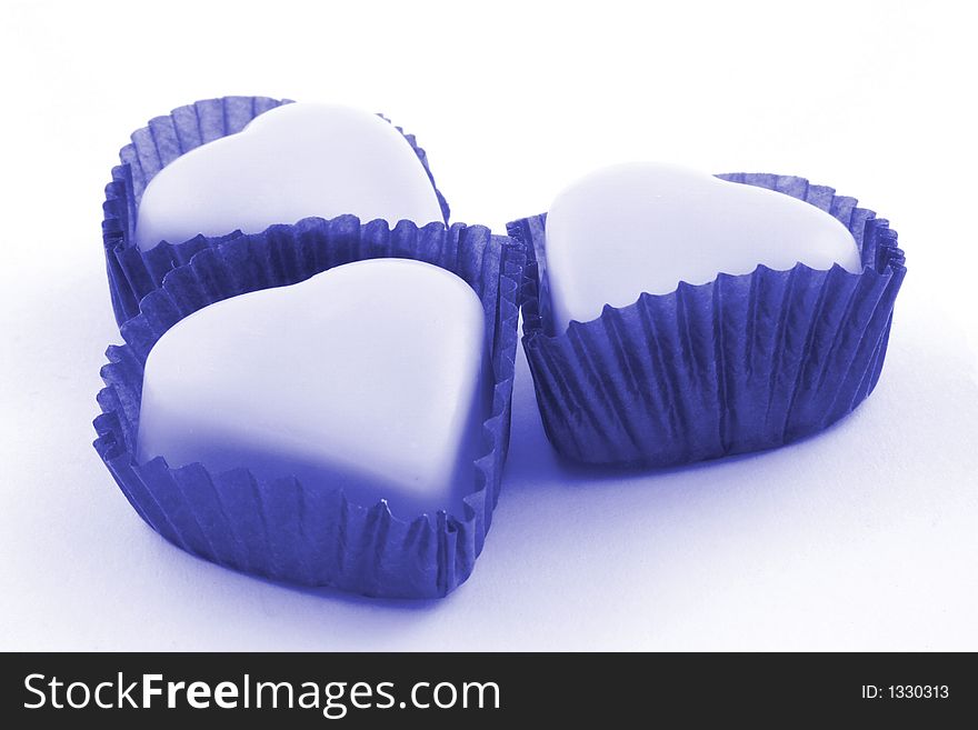 Pink love heart chocolates on a white background