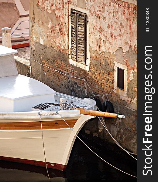 Detail of a vessel in front of old house. Detail of a vessel in front of old house