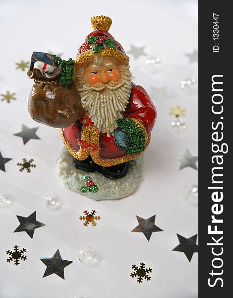 Santa Claus with presents, in front of a white background. Lighted with Dedo spots.