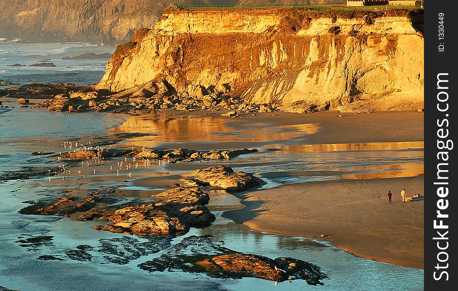 Sandy bluff reflects the golden sunset on Oregon coast. Sandy bluff reflects the golden sunset on Oregon coast.