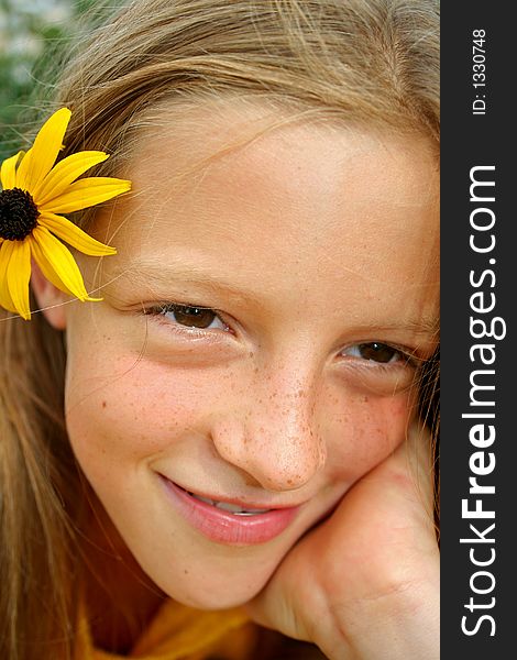 Close up of young girl with flower in hair. Close up of young girl with flower in hair