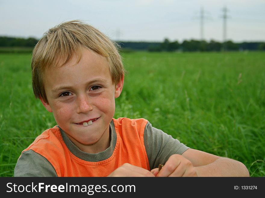 Young boy in field plating in grass