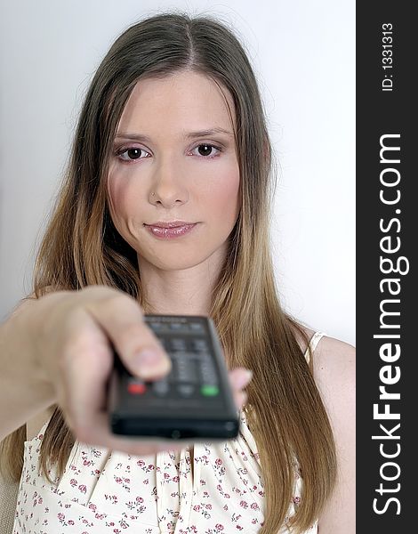 Young blond woman with a remote control. Young blond woman with a remote control