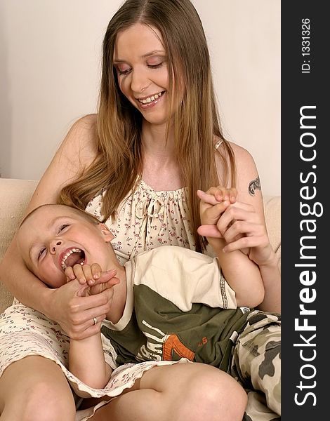 Young blond woman playing with a small boy. Young blond woman playing with a small boy